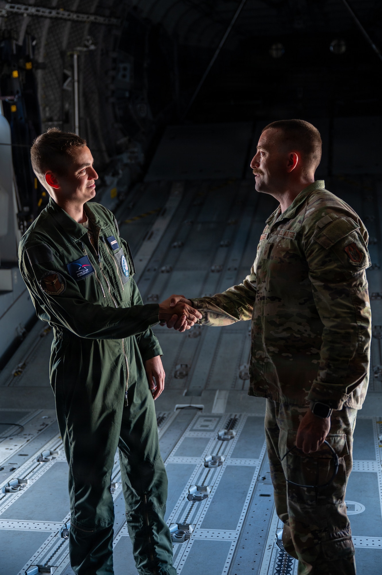 Two service members shake hands