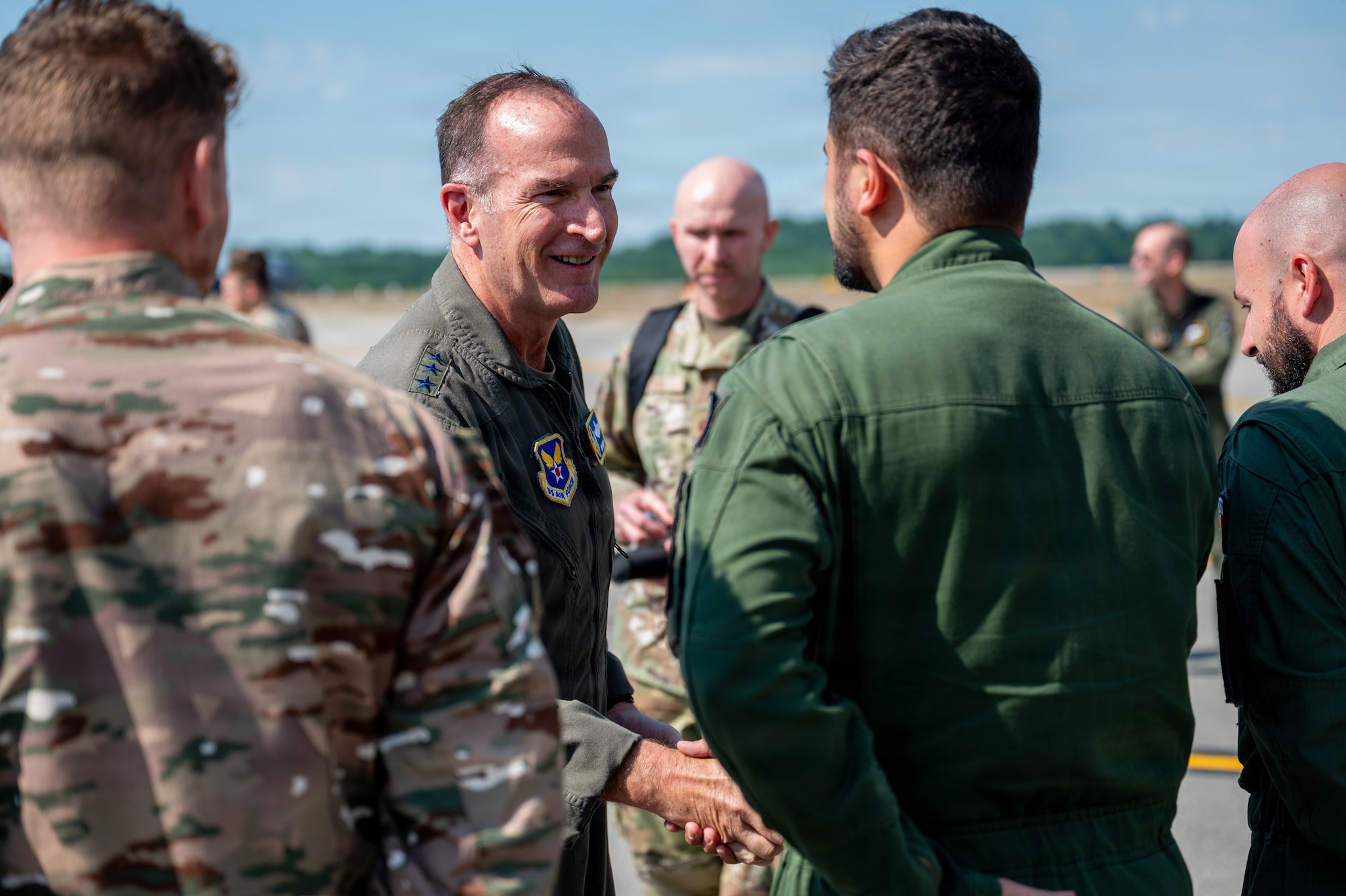 Air Force officer shakes hands with service members