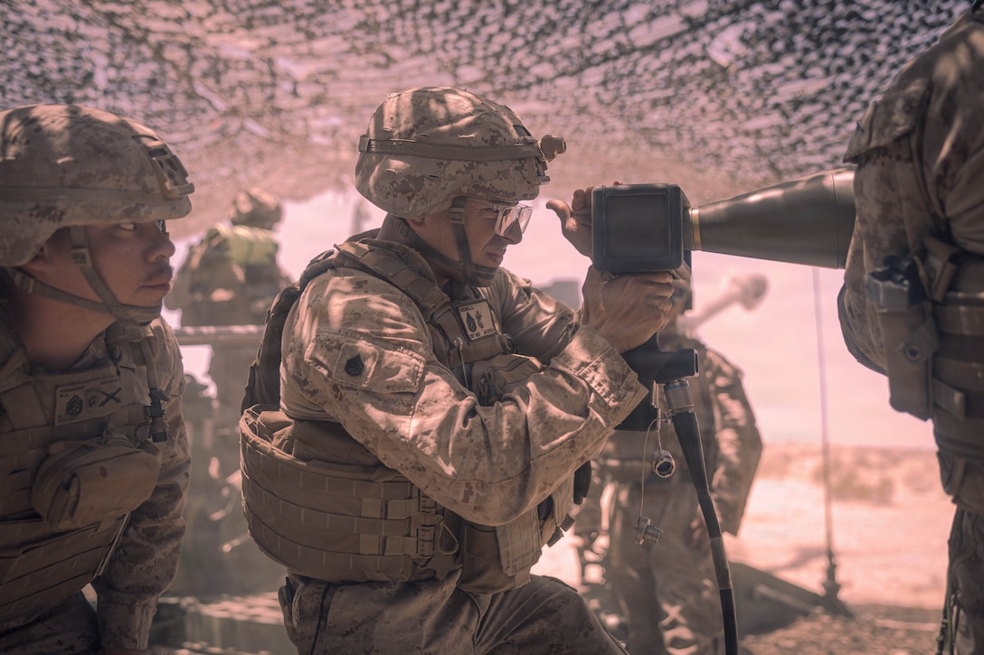 U.S. Marine Corps Staff Sgt. Dario Medina, a field artillery cannoneer with 5th Battalion, 14th Marine Regiment, sets a fuse to prepare for a fire mission while Marines conduct live artillery fire during Integrated Training Exercise 3-26 on Marine Corps Air Ground Combat Center Twentynine Palms, California, June 4, 2026. ITX is designed to generate combat readiness and ensure the Reserve Component provides critical strategic depth to the Total Force. From complex combined arms maneuvers to all-domain integration, these Marines are proving that they are ready to augment, reinforce, and fight alongside the active component at a moment's notice. (U.S. Marine Corps photo by Lance Cpl. Parker Peichel)