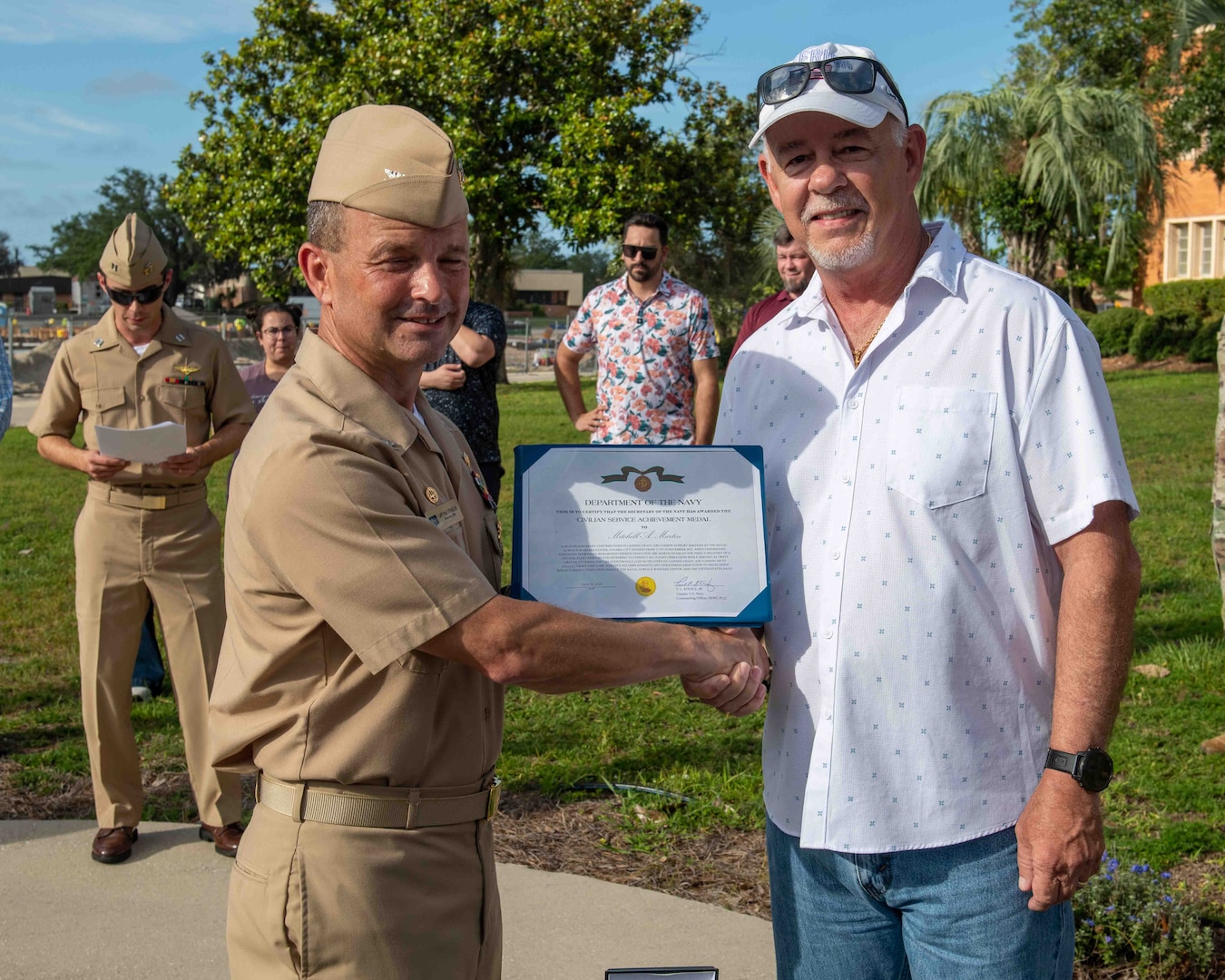 (left) Capt. Paul Stence, Jr., Naval Surface Warfare Center Panama City Division (NSWC PCD) commanding officer, presents Mitchell Martin, NSWC PCD LCAC operator and technician, with the Department of the Navy Civilian Service Achievement Medal, June 12. His actions enabled the deployment of the full complement of four LCACs to the fleet. (U.S. Navy photo by Eddie Green)