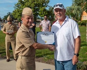 (left) Capt. Paul Stence, Jr., Naval Surface Warfare Center Panama City Division (NSWC PCD) commanding officer, presents Mitchell Martin, NSWC PCD LCAC operator and technician, with the Department of the Navy Civilian Service Achievement Medal, June 12. His actions enabled the deployment of the full complement of four LCACs to the fleet. (U.S. Navy photo by Eddie Green)