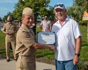 (left) Capt. Paul Stence, Jr., Naval Surface Warfare Center Panama City Division (NSWC PCD) commanding officer, presents Mitchell Martin, NSWC PCD LCAC operator and technician, with the Department of the Navy Civilian Service Achievement Medal, June 12. His actions enabled the deployment of the full complement of four LCACs to the fleet. (U.S. Navy photo by Eddie Green)