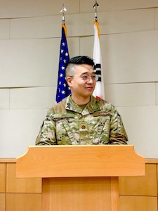 Image of Airmen talking at a podium.