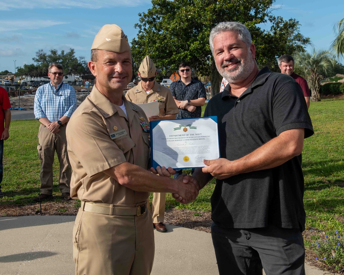 (left) Capt. Paul Stence, Jr., Naval Surface Warfare Center Panama City Division (NSWC PCD) commanding officer, presents Garrett Fulton with the Department of the Navy Civilian Service Commendation Medal, June 12. As the Landing Craft Air Cushion maintenance deputy, Fulton orchestrated a compressed schedule to complete all critical repairs, upgrades, and inspections. (U.S. Navy photo by Eddie Green)
