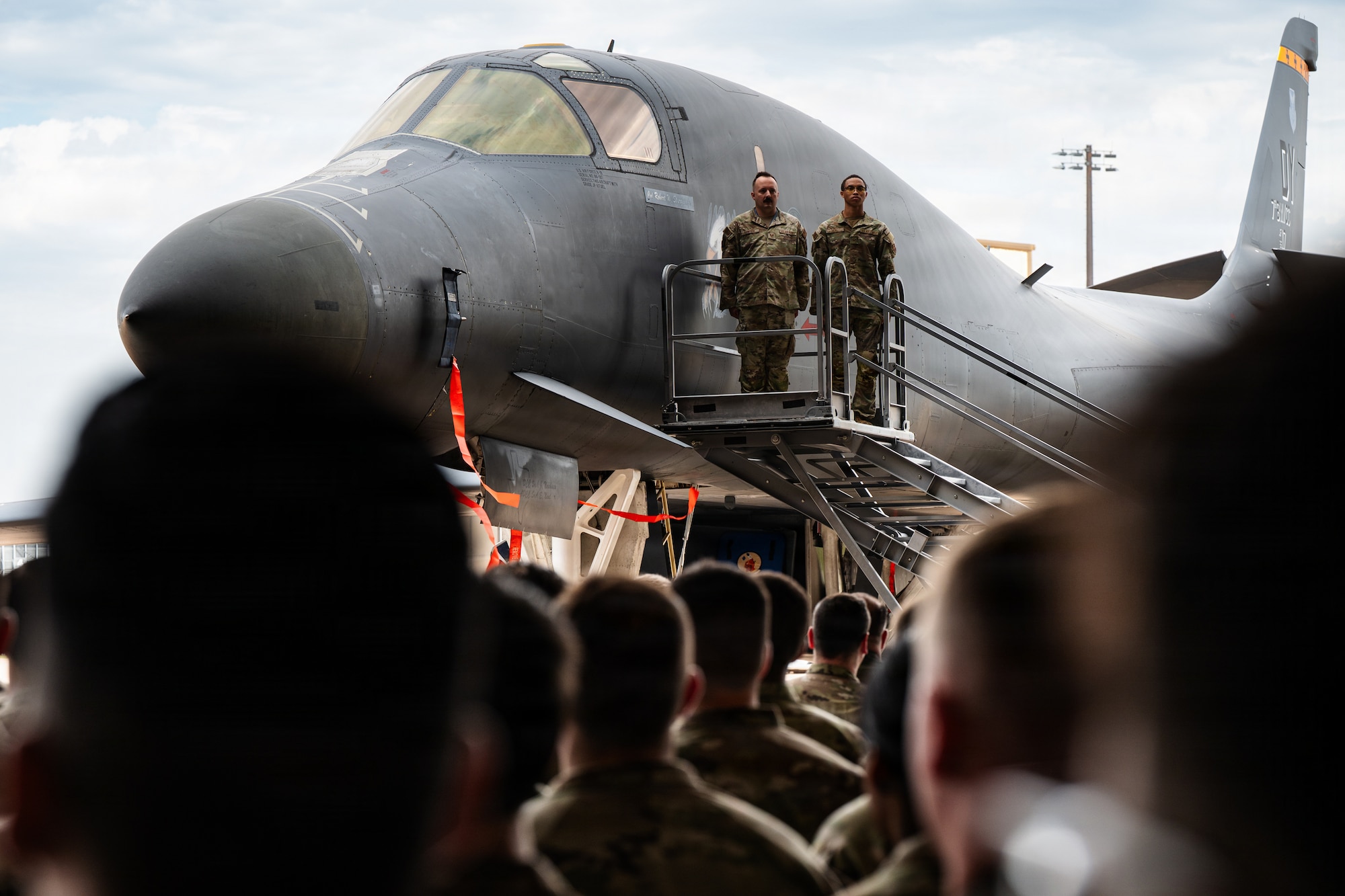 Airmen stand on stage during a formal Change of Command Ceremony