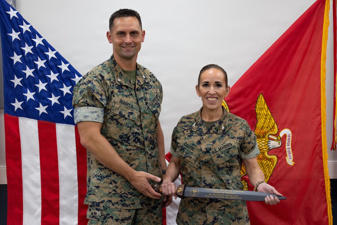 U.S. Marine Corps Lt. Col. Glenn W. Berdela Jr., left, commanding officer, 2nd Network Battalion, and Col. Juliet H. Calvin, commanding officer, Marine Corps Cyberspace Operations Group, pose for a photo during 2nd Network Bn’s 5th birthday ceremony at Marine Corps Base Camp Lejeune, North Carolina, June 3, 2026. 2nd Network Bn was activated on June 3, 2021, to ensure the operation of a resilient network that enables mission execution in the face of persistent cyber threats. (U.S. Marine Corps photo by Lance Cpl. Alyssa J. DeCrane)