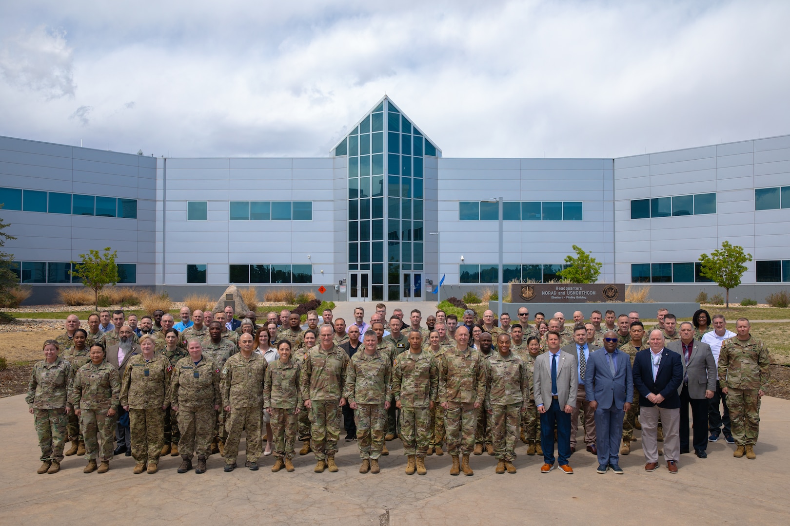 More than 100 logisticians and planners from across the joint logistics enterprise gather for a group photo during the 2026 Sustainment Rehearsal of Concept (ROC) Drill at North American Aerospace Defense Command and U.S. Northern Command headquarters on April 28, 2026. The collaborative event brought together N&NC staff, service components, Canadian allies and interagency partners to physically walk through continental distribution concepts, identify critical nodes and strengthen the homeland defense network. (Department of War photo by Blake Macias)