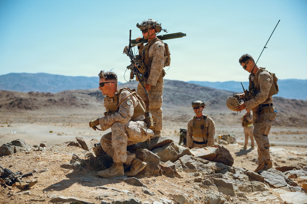 U.S. Marines with 3rd Light Armored Reconnaissance Battalion, 1st Marine Division, I Marine Expeditionary Force, await further instruction atop Machine Gun Hill at Range 410A, Marine Corps Air Ground Combat Center, Twentynine Palms, California, April 30, 2026. The exercise focused on maximizing interoperability with allied forces. (U.S. Marine Corps photo by Lance Cpl. Gracelyn Hanson)
