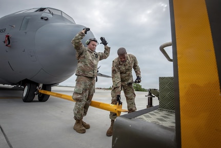 U.S. Airmen with the 123rd Airlift Wing, Kentucky Air National Guard, reposition a C-130J Super Hercules aircraft using a tow tractor on the flight line at Karup Air Base, Denmark, June 2, 2026.