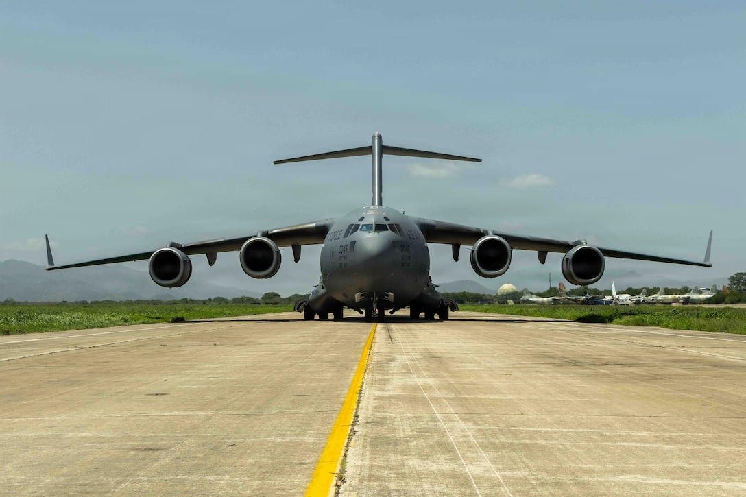 Front view of a military cargo plane on the flightline.