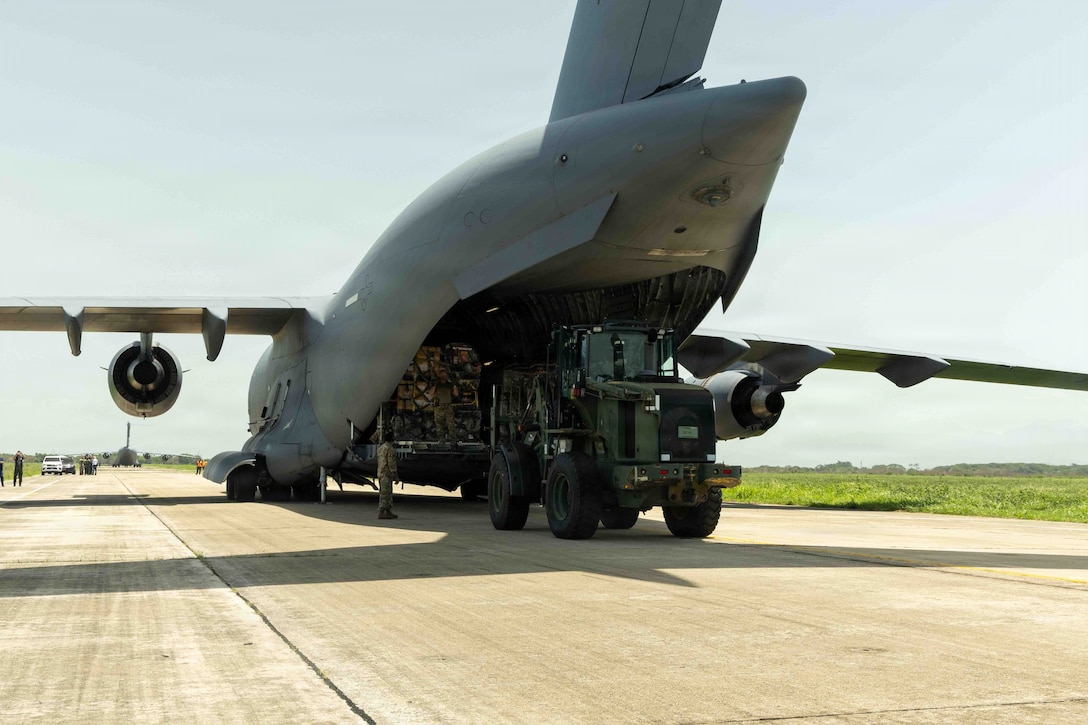 A military cargo aircraft sits on the flightline.