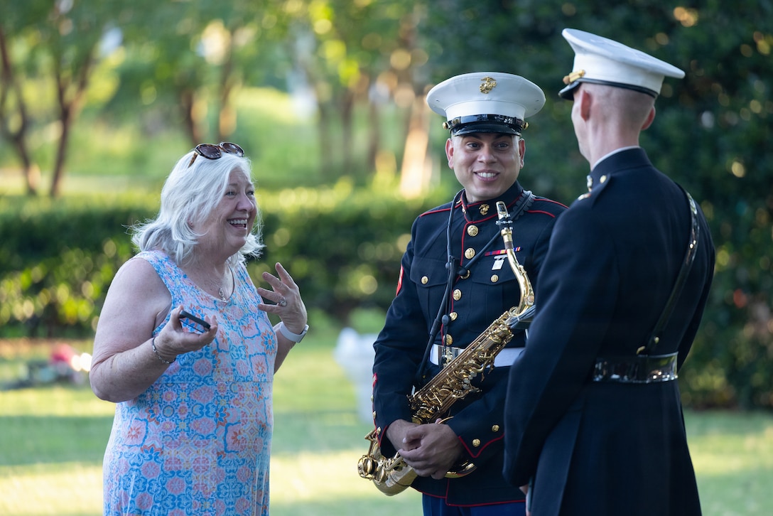 U.S. Marine Corps Cpl. Daniel Melendez Baez, left, from Puerto Rico, a saxophone musician and Chief Warrant Officer 2 John Geary, from Alaska, a band officer, both with the 2nd Marine Aircraft Wing Band, interact with local residents in Norfolk, Virginia, June 19, 2026. Fleet Week Norfolk and SAIL250 Virginia celebrate America’s maritime heritage and the nation’s 250th anniversary by bringing together U.S. and international ships, Sailors and community partners throughout Hampton Roads. (U.S. Marine Corps photo by Lance Cpl. Michael Robinson)