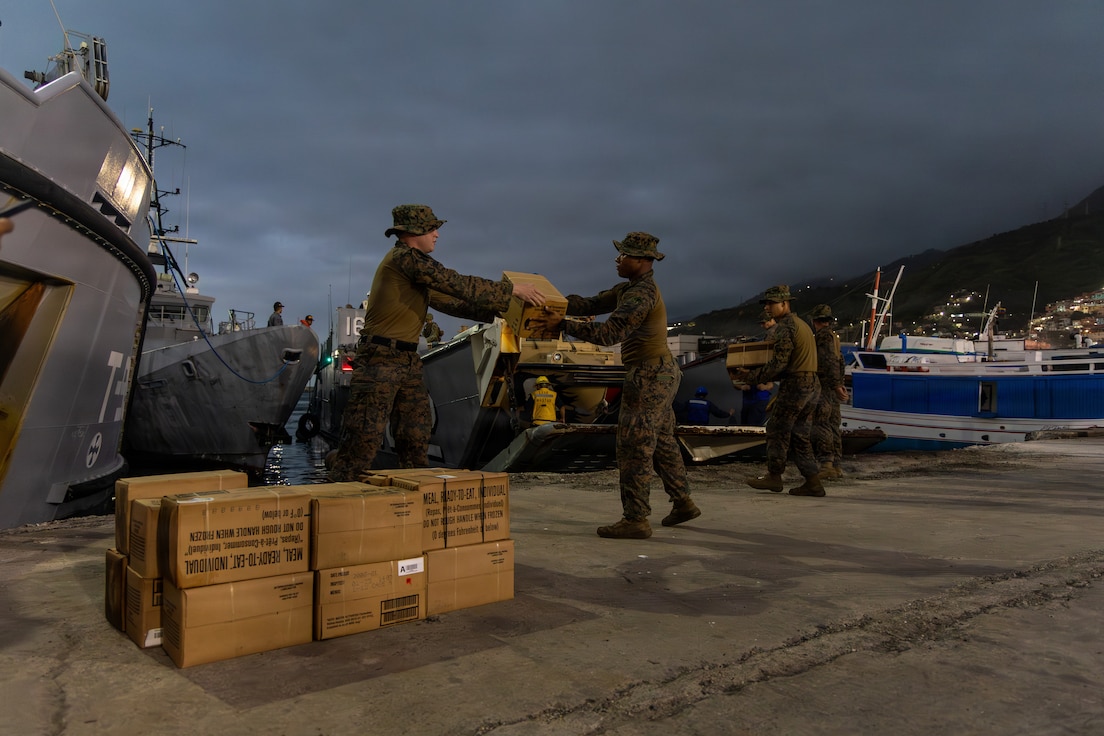 U.S. Marines offload disaster assistance supplies from a Landing Craft