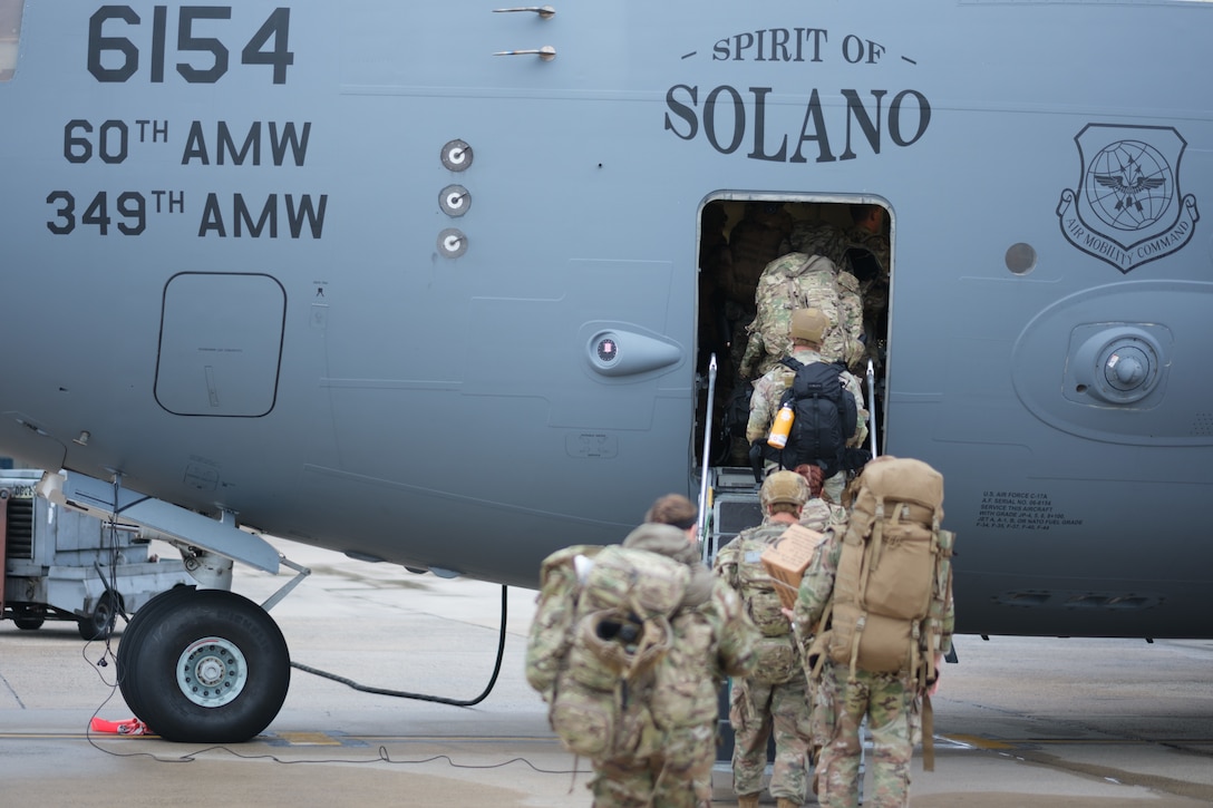 Troops board a military aircraft.