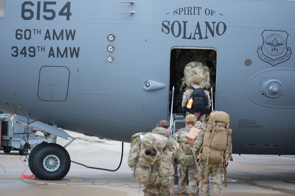 Troops board a military aircraft.