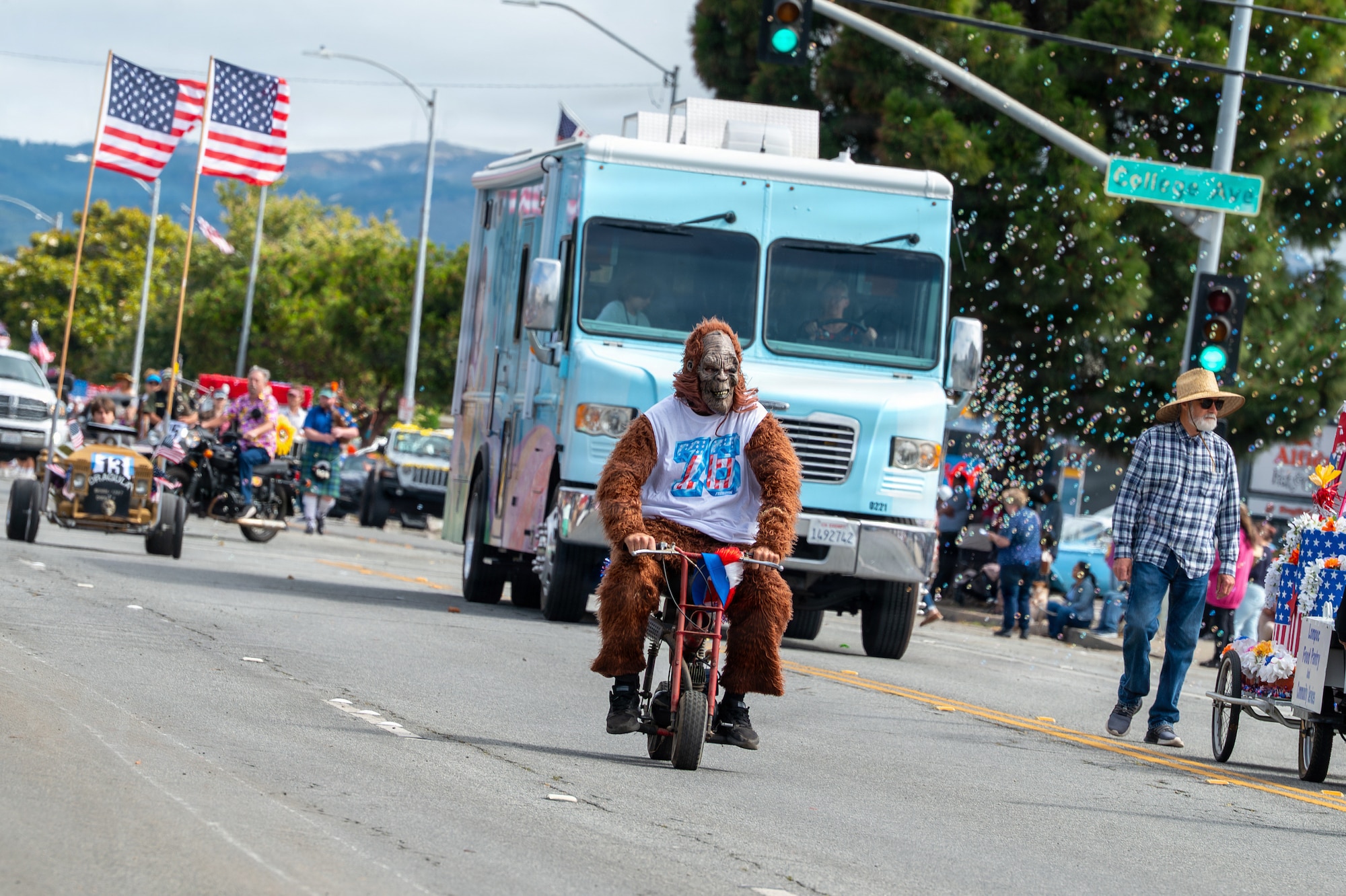 People walk and ride vehicles during a parade