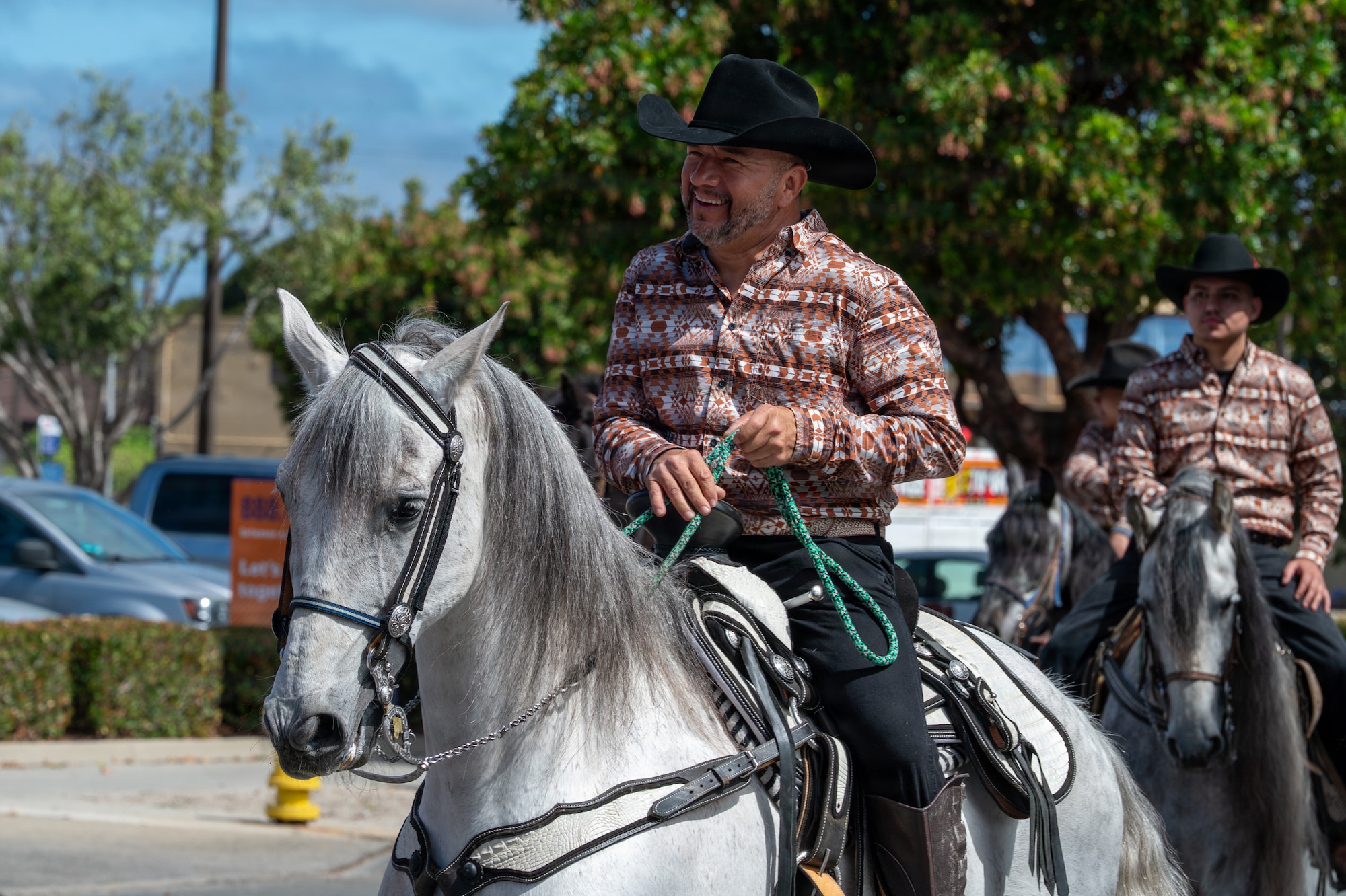 Two people ride horses