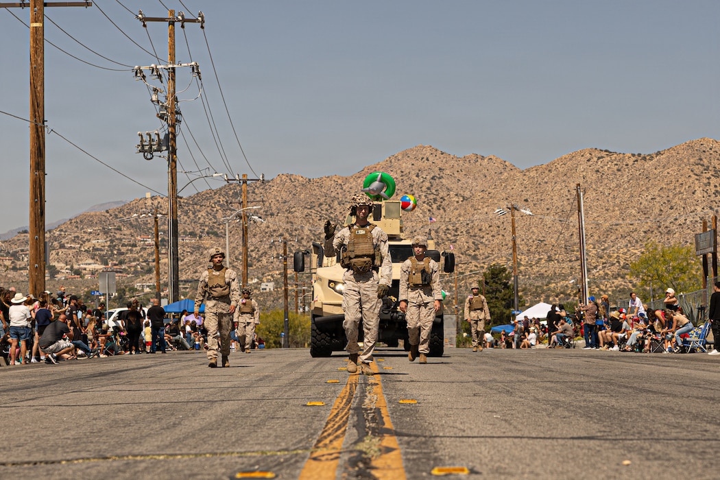 U.S. Marines with 1st Marine Division march alongside tactical vehicles in the 75th annual Grubstake Days Parade in Yucca Valley, California, May 23, 2026. The historic parade is a cornerstone of the multi-day community celebration, honoring the heritage of the Morongo Basin while paying tribute to fallen service members over the Memorial Day weekend. (U.S. Marine Corps photo by Lance Cpl. Emilio Murphy)