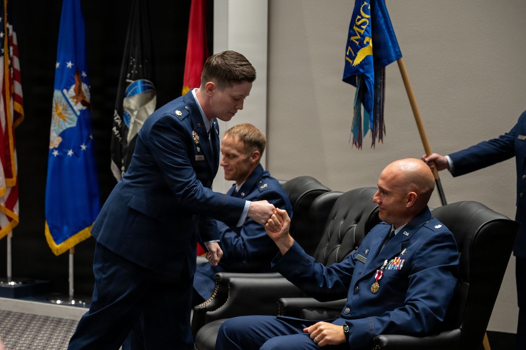 Two service members fist bump