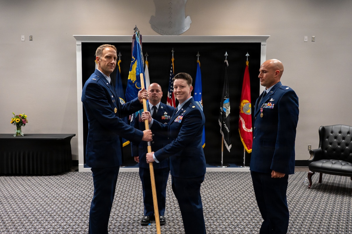 A unit's guidon is exchanged between two commanders