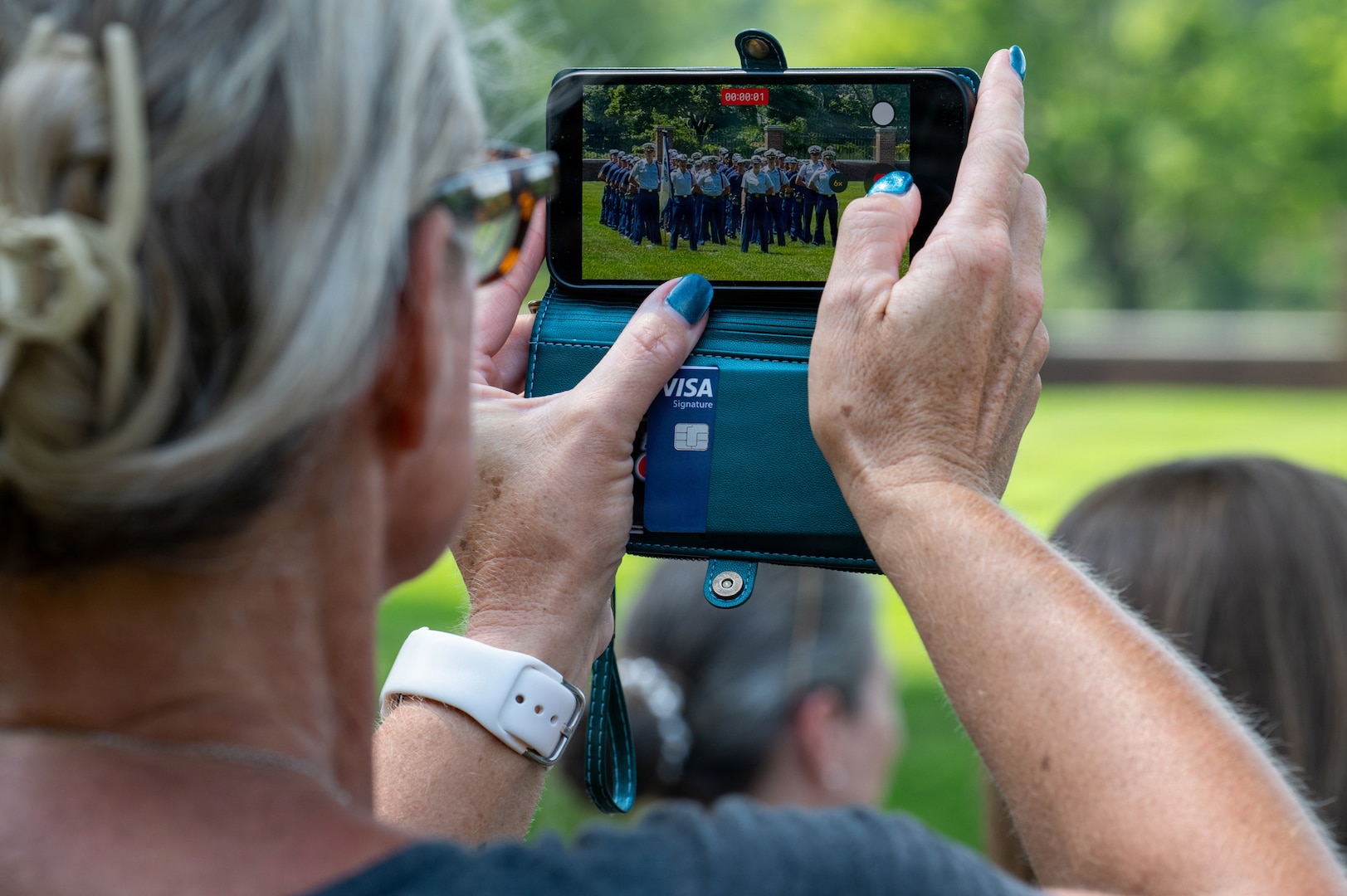 A family member of a U.S. Coast Guard Academy (USCGA) swab takes a video of swab during Day One at USCGA, New London, Connecticut, June 29, 2026. The new Class of 2030 are given 15 minutes to say goodbye to their families before they enter the seven-week training environment. (U.S. Coast Guard photo by Petty Officer Third Class Roxanna Jacobo Cruz)