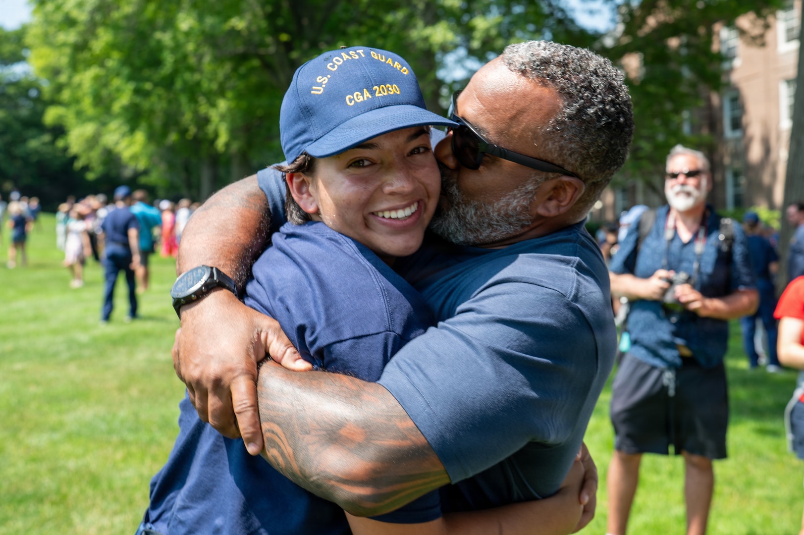 U.S. Coast Guard Academy (USCGA) swab from the Class of 2030 hug a loved one during Day One at USCGA, New London, Connecticut, June 29, 2026. The new Class of 2030 are given 15 minutes to say goodbye to their families before they enter the seven-week training environment. (U.S. Coast Guard photo by Petty Officer Third Class Roxanna Jacobo Cruz)