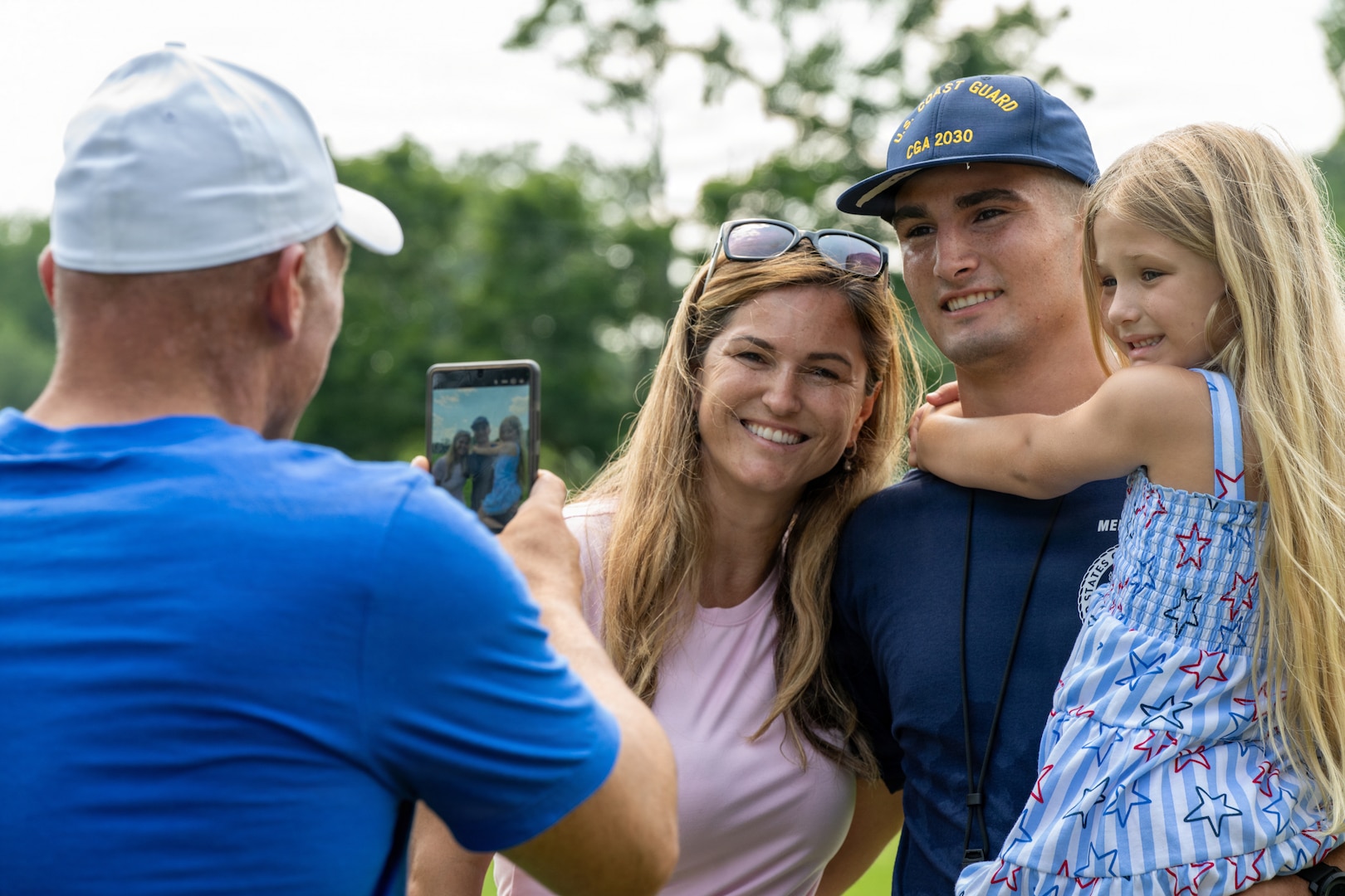 U.S. Coast Guard Academy (USCGA) swab from the Class of 2030 take a photo with loved ones during Day One at USCGA, New London, Connecticut, June 29, 2026. The new Class of 2030 are given 15 minutes to say goodbye to their families before they enter the seven-week training environment. (U.S. Coast Guard photo by Petty Officer 2nd Class Janessa-Reyanna Warschkow)