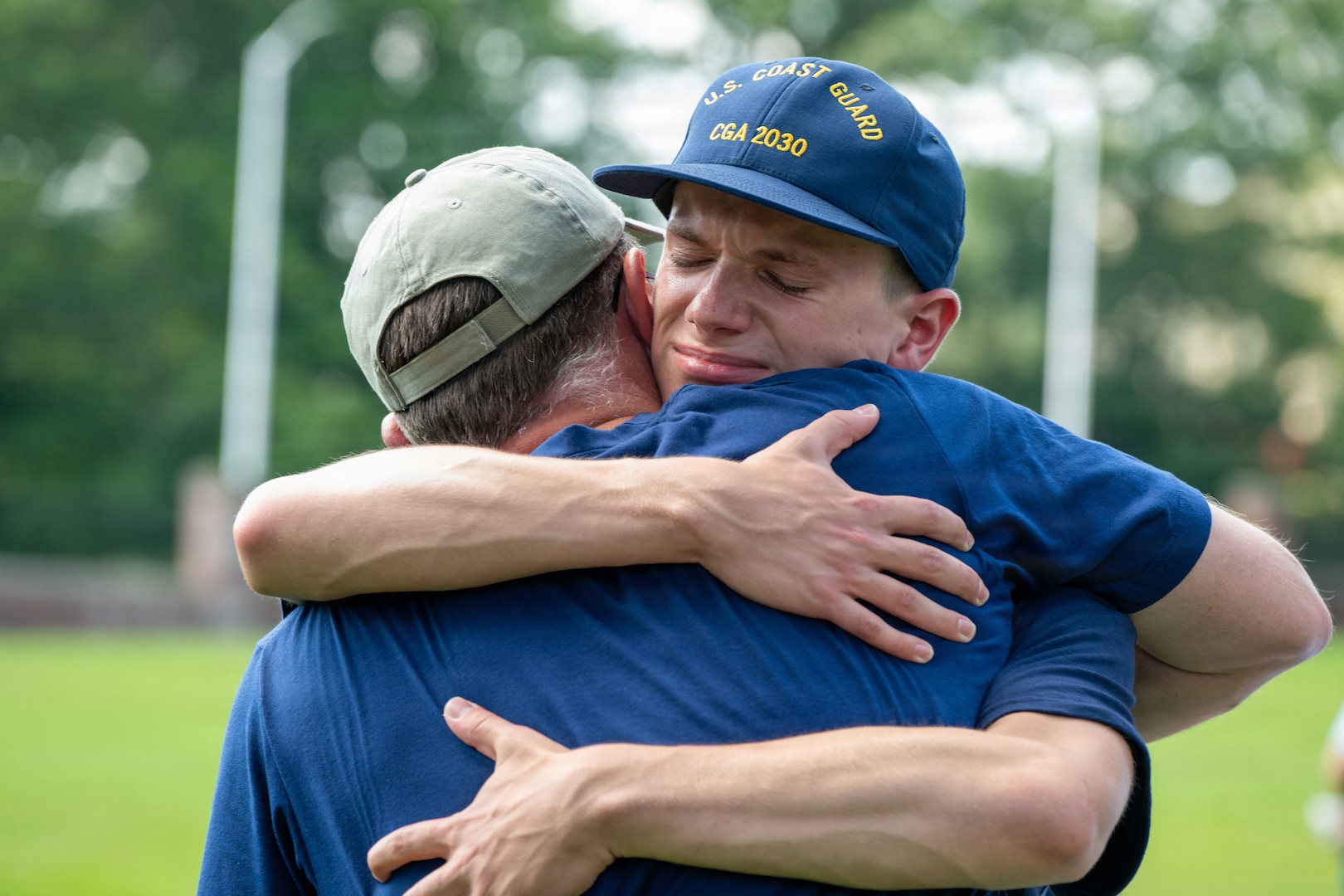 U.S. Coast Guard Academy (USCGA) swab from the Class of 2030 hug a loved one during Day One at USCGA, New London, Connecticut, June 29, 2026. The new Class of 2030 are given 15 minutes to say goodbye to their families before they enter the seven-week training environment. (U.S. Coast Guard photo by Petty Officer 2nd Class Janessa-Reyanna Warschkow)