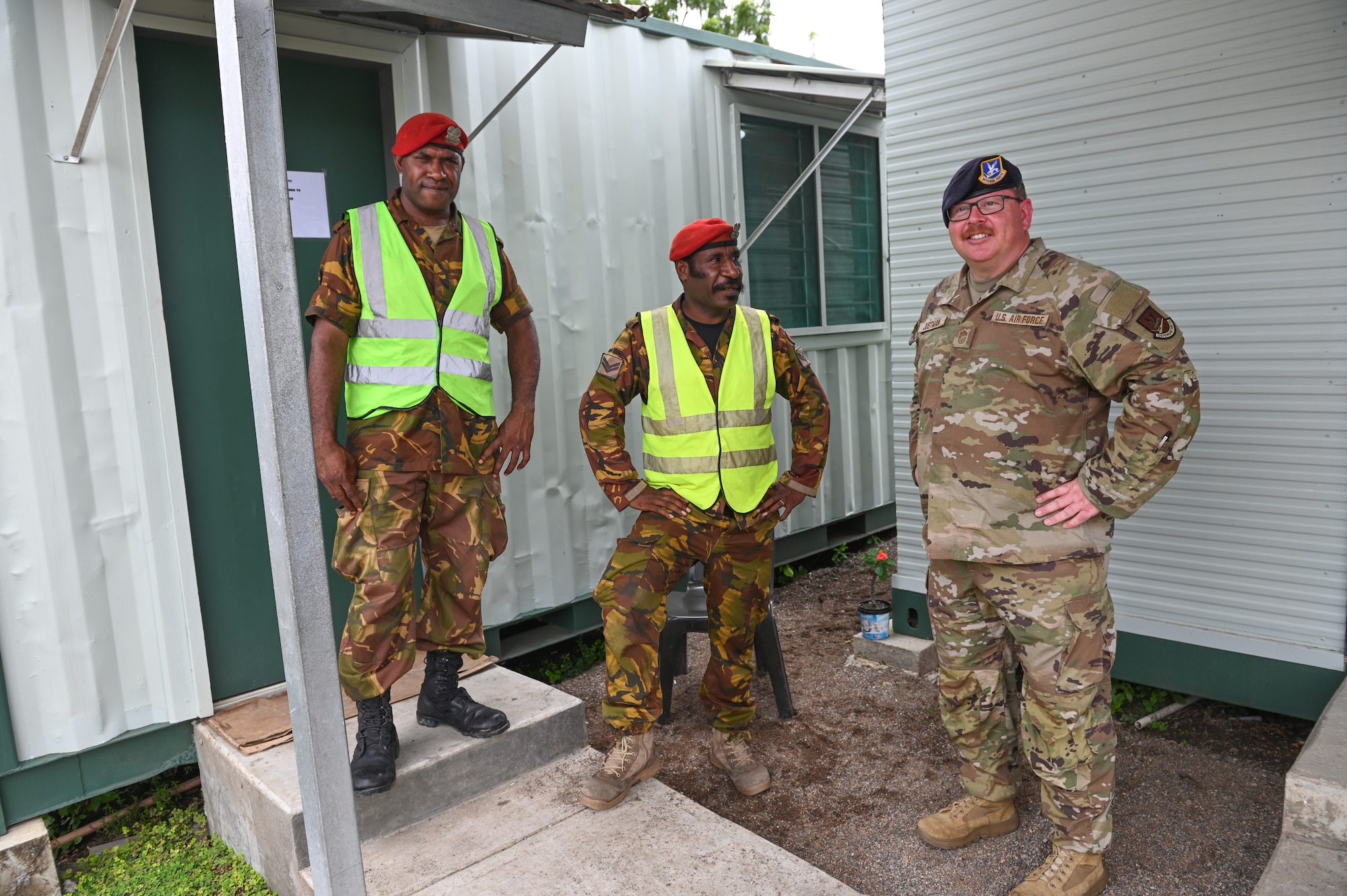 From left, Papua New Guinea Defence Force Lance Corporal Wilfred Pomun, and Corporal Arthur Wariambu, both assigned to the PNGDF Air Transport Wing and U.S. Air Force Senior Master Sgt. Joshua Justman, assigned to the 128th Air Refueling Wing, Wisconsin Air National Guard, secure an entry control point at the PNGDF Air Transport Wing, in the National Capital District, Port Moseby, Papua New Guinea March 14, 2025. The Wisconsin National Guard State Partnership Program is working with the U.S. Embassy team in PNG, and the PNG Defence Force on a consolidated exchange in PNG during fiscal year 2025 that includes four subject matter expert exchanges. (U.S. Air National Guard photo by Master Sgt. Mary Greenwood)