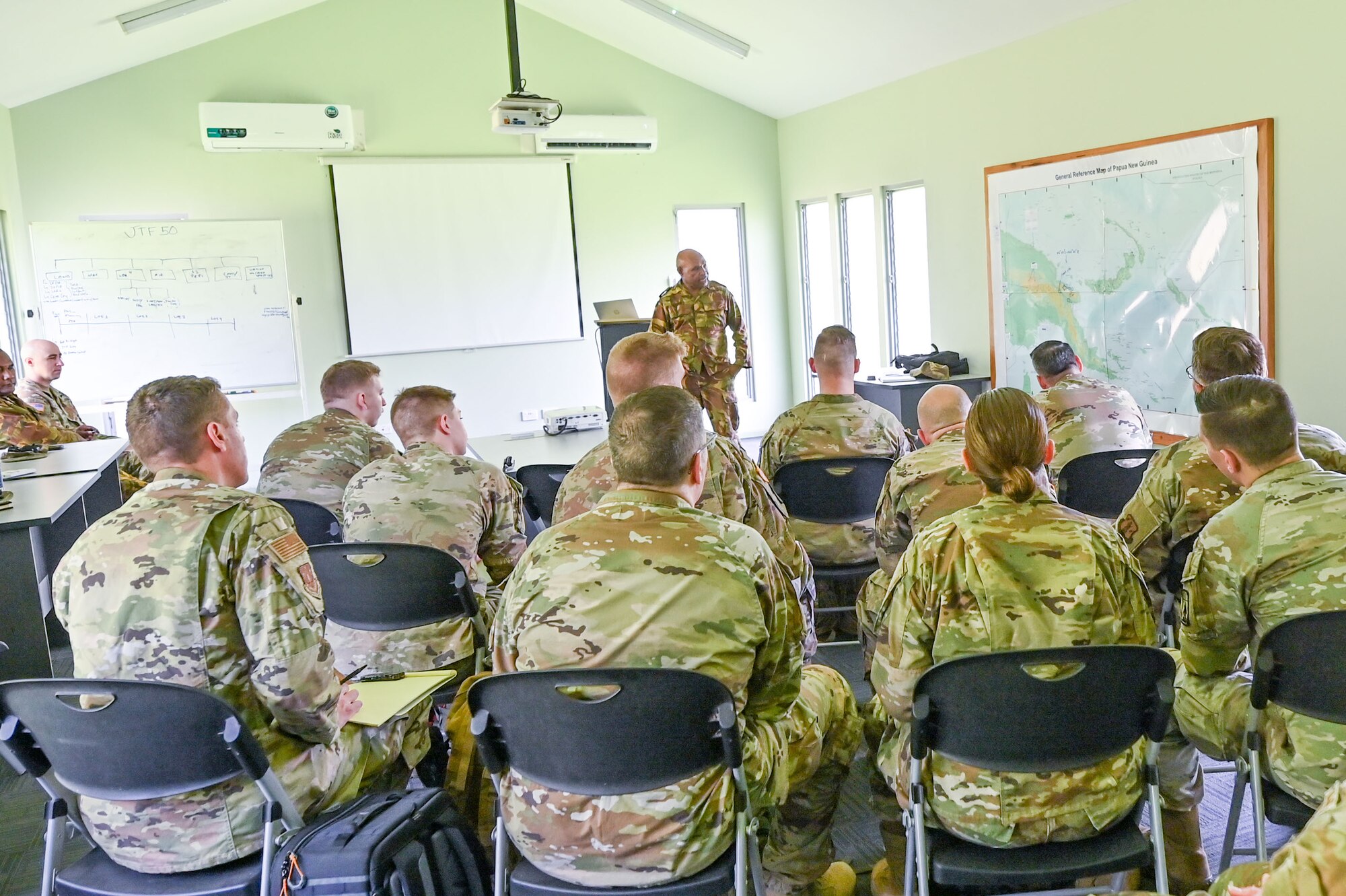 Papua New Guinea Defence Force Lt. Colonel Steven Serum, the PNGDF director of international commitment and engagement, gives a briefing to members of the Wisconsin National Guard upon their arrival for the March 2025 Consolidated State Partnership Program Exchange at Murray Barracks in Port Moresby, Papua New Guinea on March 11, 2025. The Wisconsin National Guard State Partnership Program is working with the U.S. Embassy team in PNG, and the PNG Defence Force on a consolidated exchange in Papua New Guinea during fiscal year 2025 that includes four subject matter expert exchanges. (U.S. Air National Guard photo by Master Sgt. Mary Greenwood)