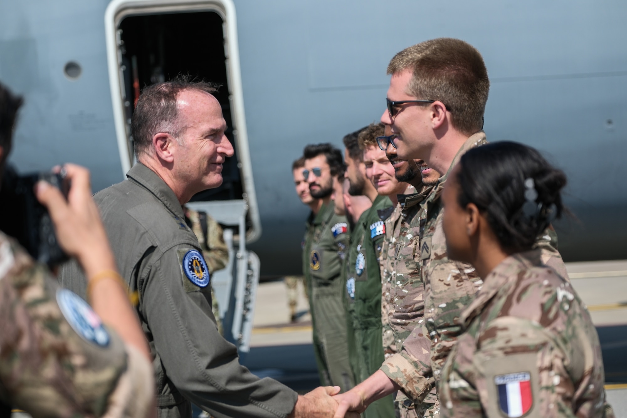 U.S. Air Force Lt. Gen. John Healy, left, chief of Air Force Reserve and commander, Air Force Reserve Command, presents his commander’s coin to member of the French Air and Space Force
