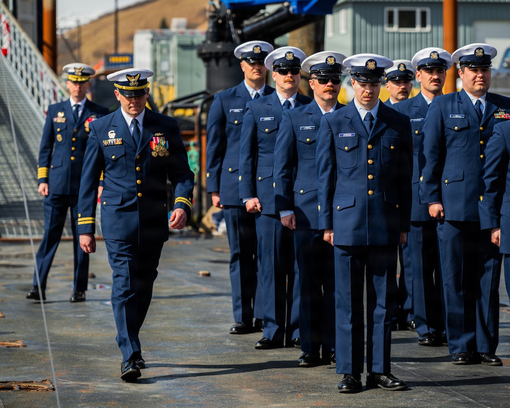 Coast Guard Lt. Frederick Scott arrives with the official party for a Change of Command ceremony in Kodiak, Alaska, May 21, 2026. Coast Guard Capt. Christopher Culpepper, commander of USCG Sector Western Alaska and U.S. Arctic, presided over the ceremony in which Lt. Kindal Holman succeeded Lt. Frederick Scott as commanding officer of the Cunningham. (U.S. Coast Guard photo by Petty Officer 3rd Class Cameron Snell)