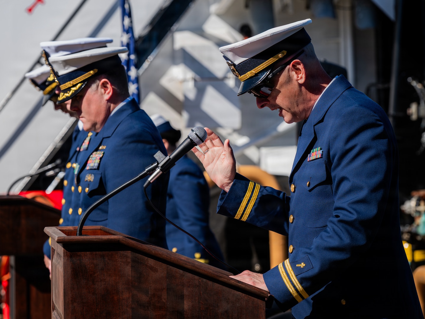 Navy Lt. Clay Hamrick, chaplain for Coast Guard Base Kodiak, delivers a benediction during a change of command ceremony aboard Coast Guard Cutter Cypress (WLB 210) in Kodiak, Alaska, June 25, 2026. Change of command ceremonies are a formal naval tradition that are intended to strengthen respect when the responsibility and authority of a commanding officer is transferred to another. (U.S. Coast Guard photo by Petty Officer 3rd Class Cameron Snell)