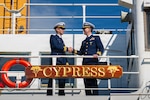 Coast Guard Lt. Cmdr. Austin Condra (left), incoming commanding officer of Coast Guard Cutter Cypress (WLB 210), shakes hands with Cmdr. James Toohey (right), outgoing commanding officer of the Cypress, following the cutter’s change of command ceremony in Kodiak, Alaska, June 9, 2026. Condra assumed command from Toohey following his tour as commanding officer.
(U.S. Coast Guard photo by Petty Officer 3rd Class Nathan Bishop)