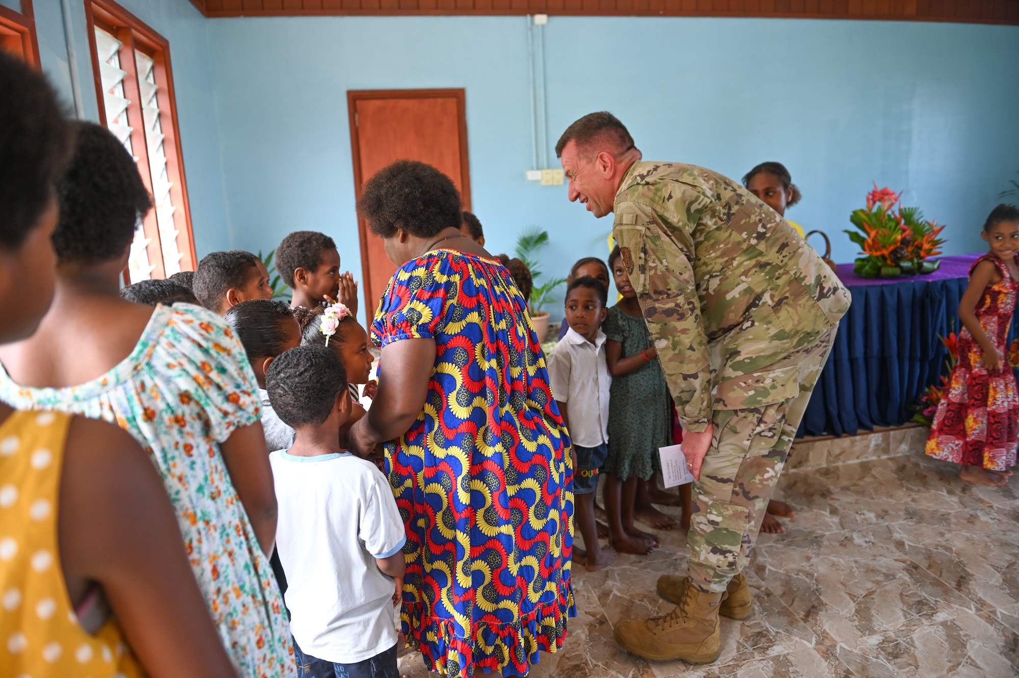 U.S. Air Force Lt. Col. James Buckman, assigned to the 115th Fighter Wing, Wisconsin Air National Guard, visits with children during a religious service at Eagle Wing Chapel, Kiki Barracks, Papua New Guinea Defence Force Air Transport Wing, in the National Capital District, Port Moseby, Papua New Guinea March 16, 2025. The Wisconsin National Guard State Partnership Program is working with the U.S. Embassy team in PNG and the PNGDF on a consolidated exchange in PNG during fiscal year 2025 that includes four subject matter expert exchanges. (U.S. Air National Guard photo by Master Sgt. Mary Greenwood)