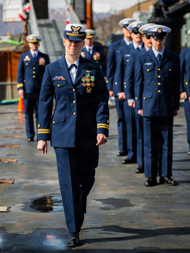 Coast Guard Lt. Kindal Holman, commanding officer of USCGC Earl Cunningham (WPC 1159), arrives with the official party for the cutter's Change of Command ceremony in Kodiak, Alaska, May 21, 2026. Coast Guard Capt. Christopher Culpepper, commander of USCG Sector Western Alaska and U.S. Arctic, presided over the ceremony in which Lt. Kindal Holman succeeded Lt. Frederick Scott as commanding officer of the Cunningham. (U.S. Coast Guard photo by Petty Officer 3rd Class Cameron Snell)