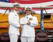 NAVAL AIR STATION NORTH ISLAND, Calif. (June 26, 2026) Capt. Phillip Sylvia Jr., commander, Submarine Squadron 11, left, presents a Meritorious Service Medal to Cmdr. Christian Rivera during the change of command ceremony for Undersea Rescue Command (URC) onboard Naval Air Station North Island, June 26, 2026. During the ceremony, Rivera was relieved by Cmdr. Michael Mowry as commanding officer of URC.  URC, comprised of active and Reserve component Sailors, and civilian contractors, is the Navy’s only submarine rescue-capable command ready to deploy around the world in the event of a submarine emergency. (U.S. Navy photo by Mass Communication Specialist 2nd Class Rashan Jefferson)