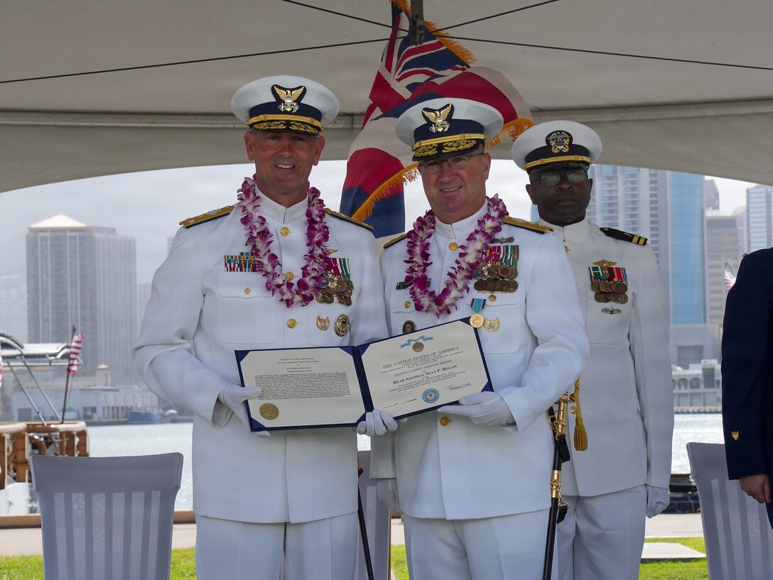 Vice Adm. Buzzella and Rear Adm. Regan present Rear Adm. Regan's departing award.