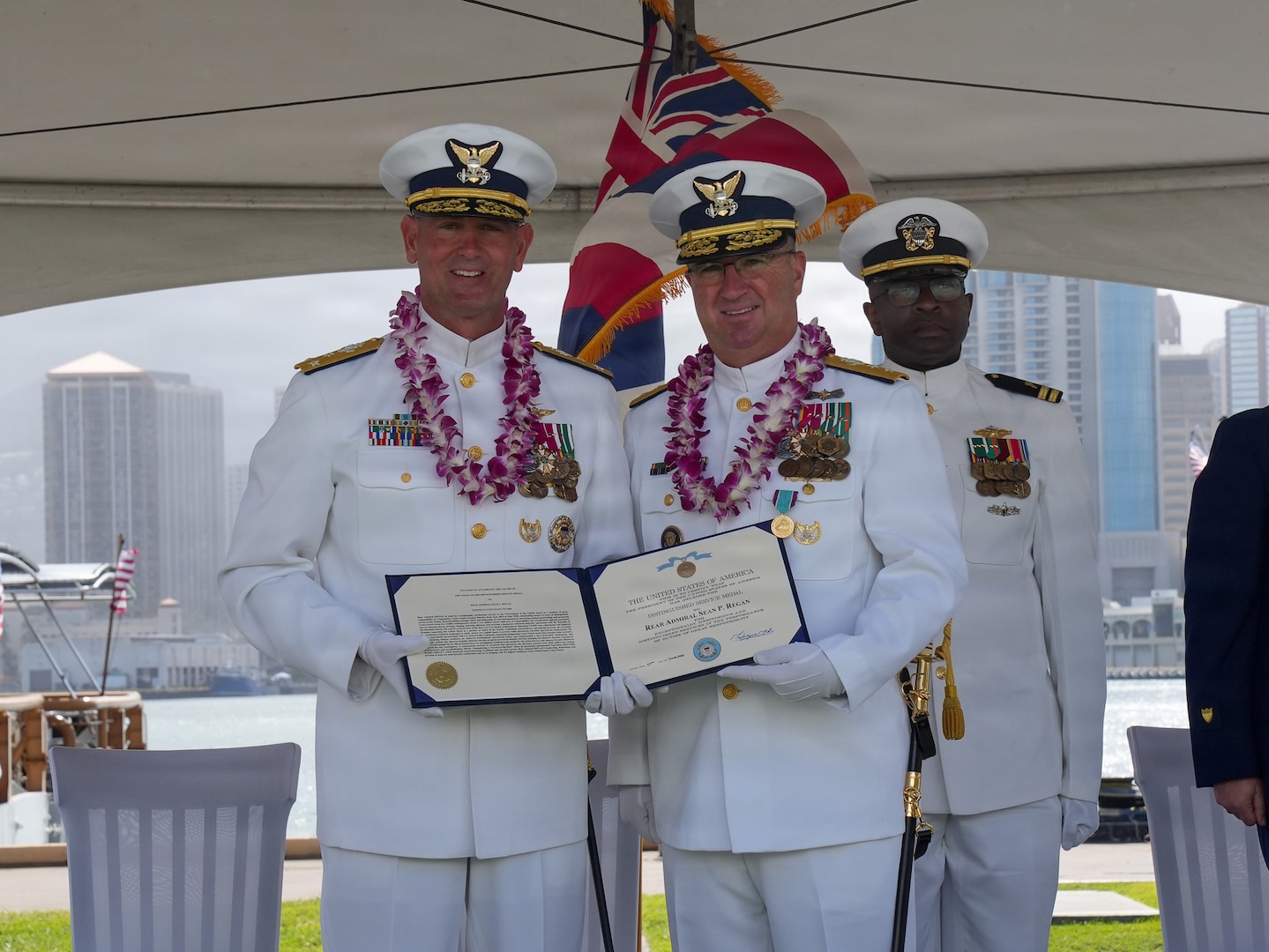 Vice Adm. Buzzella and Rear Adm. Regan present Rear Adm. Regan's departing award.