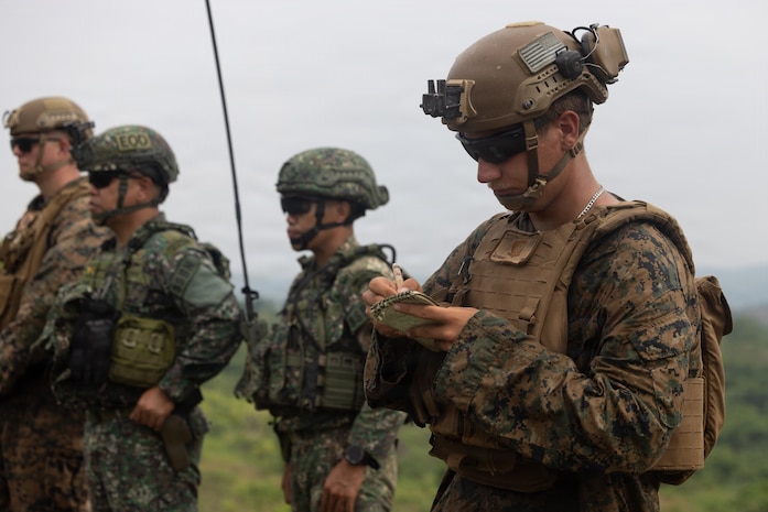 U.S. Marine Corps Lance Cpl. Nathaniel T. Gutierrez, a radio operator with 3rd Littoral Combat Team, 3rd Marine Littoral Regiment, 3rd Marine Division, takes notes while observing a Neros Archer live-fire range as part of KAMANDAG 10 at Fort Magsaysay, Nueva Ecija, Philippines, June 15, 2026.