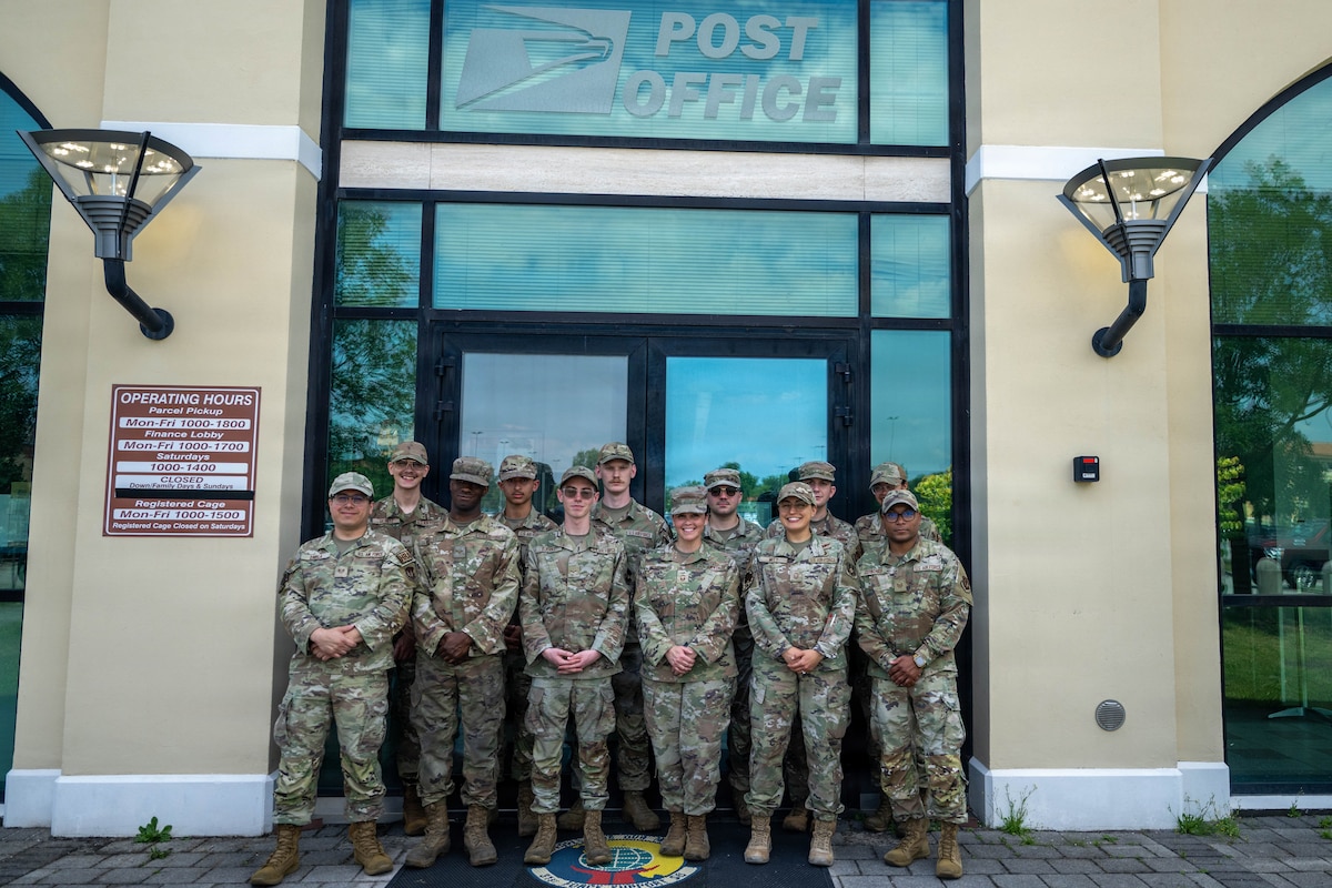 U.S. Air Force Airmen assigned to the Aviano Air Base Post Office pose for a group photo at Aviano Air Base, Italy, June 23, 2026.