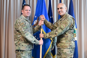 Brig. Gen. Jason Voorheis, left, appoints Col. Brian Viola as Kessel Run’s senior materiel leader during a ceremony at the Minuteman Commons, here, June 25. Voorheis is the Department of the Air Force Portfolio Acquisition Executive for Command, Control, Communications and Battle Management. Kessel Run is a division within C3BM focused on delivering resilient command and control and targeting software capabilities that provide operators with decision advantage. (Official Air Force photo by Richard Blumenstein).