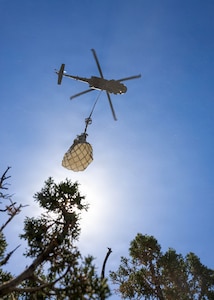 A UH-60 Black Hawk assigned to the 2-211th Aviation Battalion air lifts a dinosaur fossil in southern Utah, June 13, 2026.