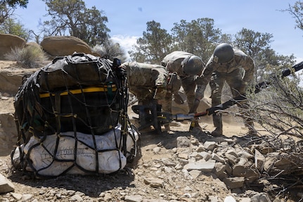 Utah National Guard Soldiers assigned to the 19th Special Forces Group (Airborne), attach a cargo net holding dinosaur bones to a UH-60 Black Hawk during an air lift in southern Utah, June 13, 2026.