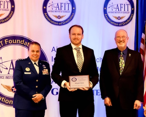 The Air Force Institute of Technology and the AFIT Foundation and Association of Graduates recognized five alumni for their outstanding career achievements in a ceremony on  June 19.  Lt. Gen. Linda S. Hurry, commander, Air Force Materiel Command, and AFIT alumnus, was the featured speaker.  The Young Alumni Award was presented to Wyatt Rabe (center) by Lt. Gen. Linda S. Hurry, commander, Air Force Materiel Command (left) and Dr. Lance Chenault, AFIT Foundation and Association of Graduates president (right).
