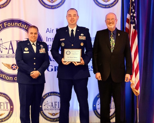The Air Force Institute of Technology and the AFIT Foundation and Association of Graduates recognized five alumni for their outstanding career achievements in a ceremony on June 19.  Lt. Gen. Linda S. Hurry, commander, Air Force Materiel Command, and AFIT alumnus, was the featured speaker.  The Young Alumni Award was presented to Col. Brian Bohan, Ph.D. (center), by Lt. Gen. Linda S. Hurry, commander, Air Force Materiel Command (left) and Dr. Lance Chenault, AFIT Foundation and Association of Graduates president (right).  (Contributed photo)