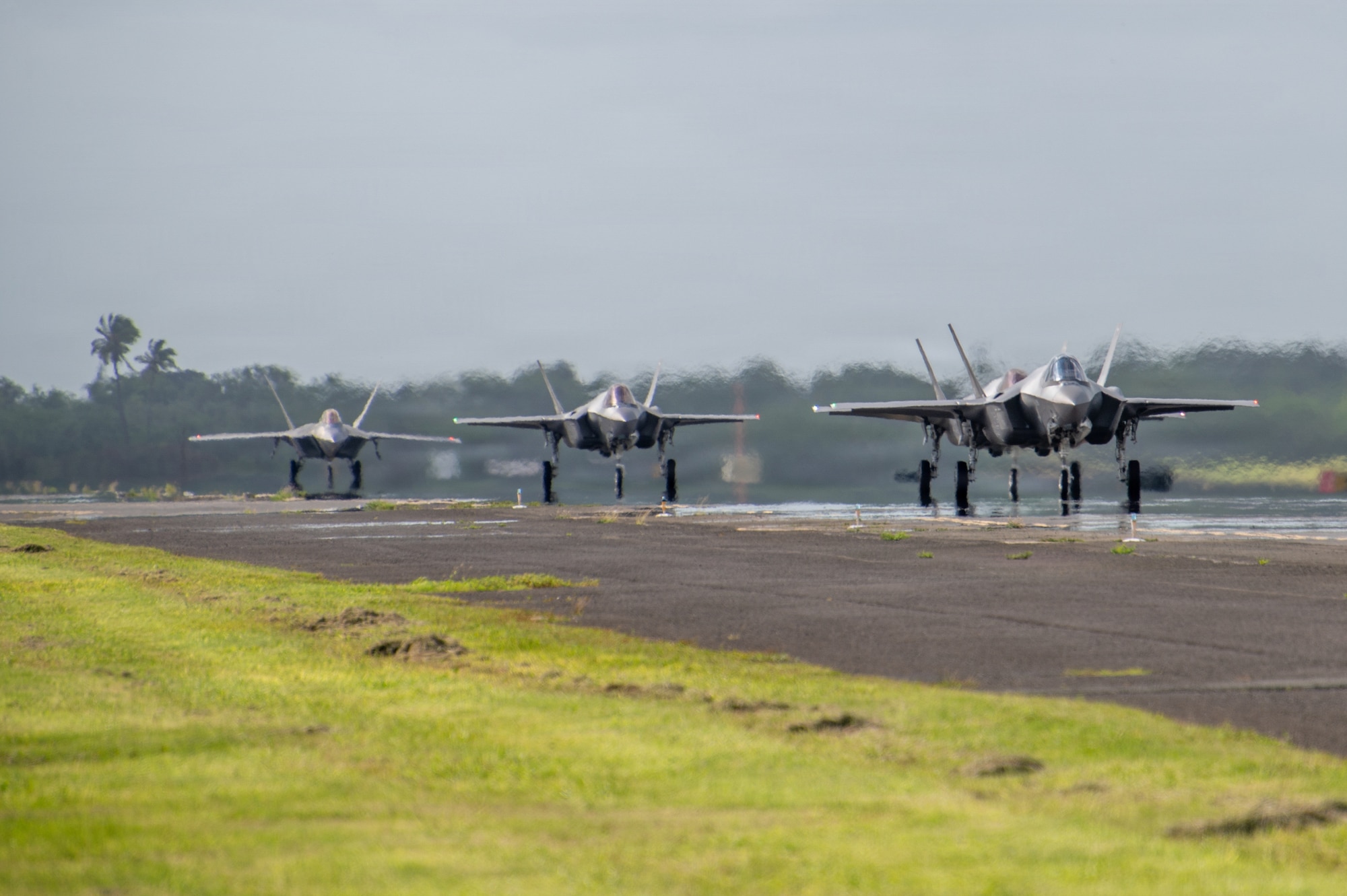 U.S. Air Force F-22 Raptor aircraft assigned to the 199th Fighter Squadron, Hawaii Air National Guard, left, and U.S. Air Force F-35A Lightning II aircraft assigned to the 115th Fighter Wing, Wisconsin Air National Guard, taxi for launch during exercise Sentry Aloha 26-1 at Joint Base Pearl Harbor-Hickam, Hawaii, Jan. 14, 2026. Sentry Aloha is built around Dissimilar Air Combat Training, which challenges pilots to engage in combat scenarios against aircraft with different performance capabilities. (U.S. Air National Guard photo by Master Sgt. Mary Greenwood)