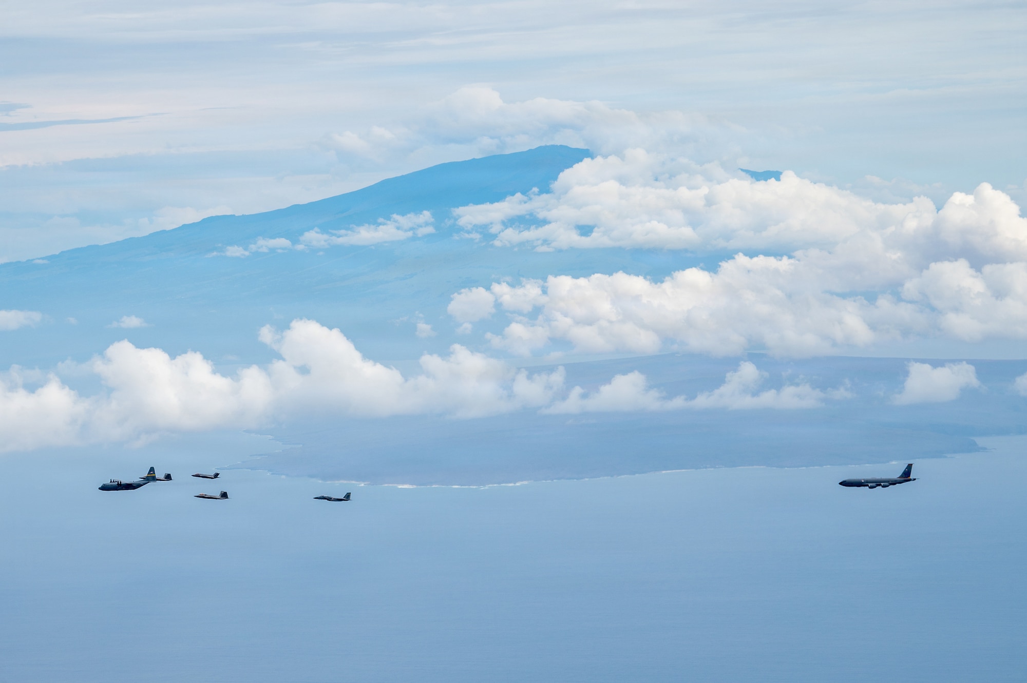 A U.S. Air Force F-35A Lightning II aircraft assigned to the 115th Fighter Wing, Wisconsin Air National Guard, U.S. Air Force F-22 Raptor aircraft assigned to the 199th Fighter Squadron, Hawaii Air National Guard, a U.S. Air Force F-15C/D Eagle aircraft, assigned to the 159th Fighter Wing, Louisiana Air National Guard, a C-130H Hercules assigned to the 153rd Airlift Wing, Wyoming Air National Guard, and a KC-135 Stratotanker assigned to the 128th Air Refueling Wing, WIANG, fly in formation during exercise Sentry Aloha 26-1, over the Pacific Ocean, Jan. 20, 2026. Sentry Aloha is built around Dissimilar Air Combat Training, which challenges pilots to engage in combat scenarios against aircraft with different performance capabilities. (U.S. Air National Guard photo by Master Sgt. Mary Greenwood)