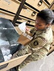 A Soldier prepares medical supplies for shipping and delivery to customer.