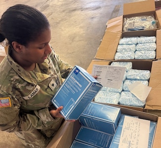 A Soldier prepares medical supplies for shipping and delivery to customer.